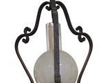 wrought iron hanging light fixture with a glass shade