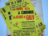 several yellow and black concert posters on a white surface