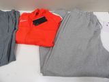 two pairs of grey and orange sweatpantss and a red jacket