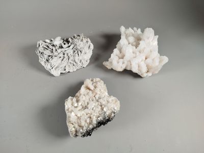 three different types of rocks on a table with a gray background