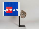 an image of a sculpture of a rock and a piece of paper on a stand