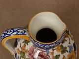 a small vase with a flower design on it