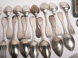a lot of spoons and forks that are on the table