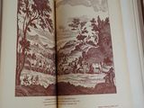 an open book with a picture of a landscape on it
