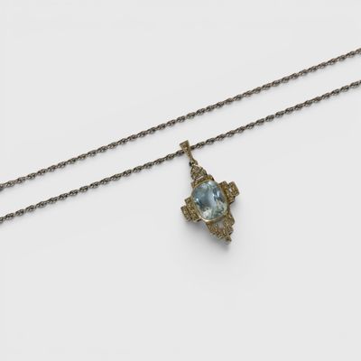 an image of a necklace with a blue stone on a chain