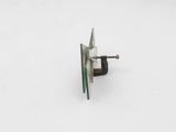 a small metal object that is on a white surface