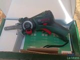 a cordless drill in a box with a key in it