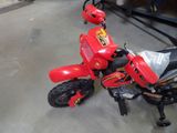 a small red motorcycle that is parked in a garage