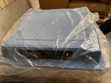 a television sitting on top of a box wrapped in plastic
