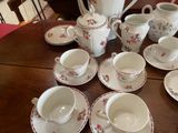 a lot of cups and saucers on the table