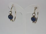 pair of earrings with lapis and pearls on a white background