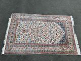 un tapis orné d'un motif floral est posé par terre