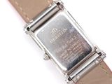 a silver watch with a brown leather strap on a white surface