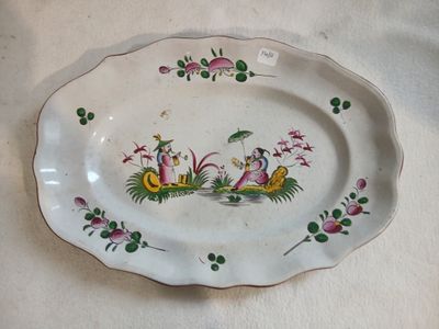 a white plate with a picture of a bird and flowers on it