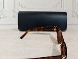 the sunglasses are laying on the floor next to a black case