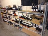 bottles of wine sit on shelves in a wine cellar