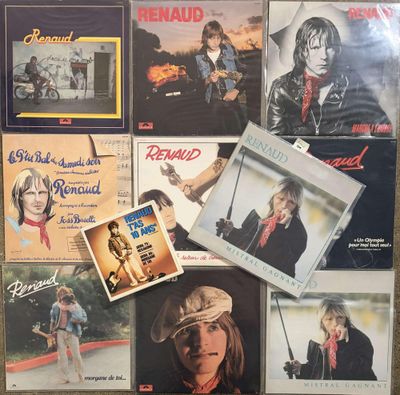 several albums of various music are on display on a table