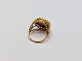 a close up of a gold ring on a white surface