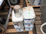 several buckets of water sitting on a pallet next to a microwave