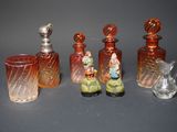 five glass bottles with figurines in them on a table