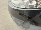 a close up of a car ' s headlight with a sticker on it