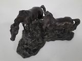statue of a horse and a dog on a rock on a white background