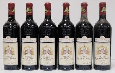 six bottles of wine are lined up on a table