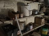 many pots and pans on the shelves in the room