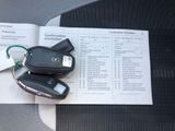 two car keys sitting on top of a book on a table