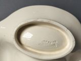a close up of a white pitcher with a lid