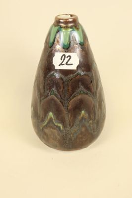 a small vase with a number on it sitting on a table