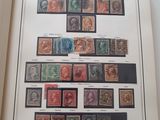 an open book with a picture of a collection of stamps on it