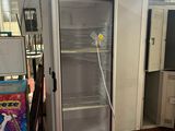 an image of a refrigerator in a room with a lot of items