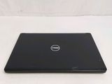 the dell laptop is sitting on a white surface with a white background