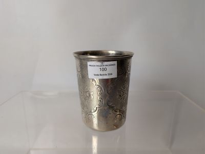 a silver cup sitting on a clear table