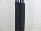 two black poles that are on a white surface