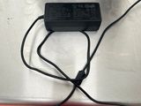 a person standing next to a box with a charger attached to it