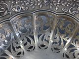 a silver plate with a decorative design on it