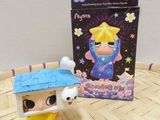 a small figurine that is sitting next to a box
