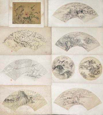 several old chinese paper fans with drawings on them on a table