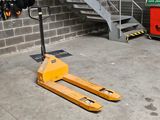 a yellow forklift sitting in front of a building