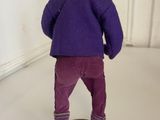 a small figurine of a person standing on a skateboard