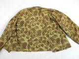 a close up of a camouflage jacket on a white surface