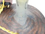 a glass vase with a yellow cord around it