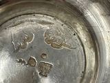 a silver plate with a flower design on it