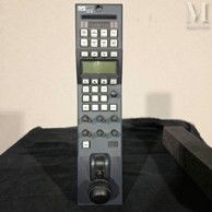a remote control sitting on a table next to a remote control