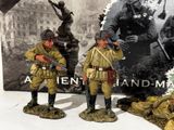 three figurines of soldiers standing next to each other