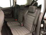 the interior of a car with two rows of seats and a steering wheel