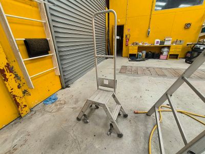 une plate-forme métallique avec une échelle, à côté d'un bâtiment jaune