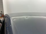 a close up of a car ' s hood with a hole in it